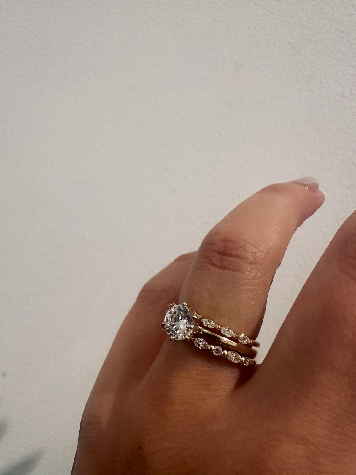 Marquise Gaze wedding band in 14kt yellow gold with prong set marquise diamonds worn on the hand