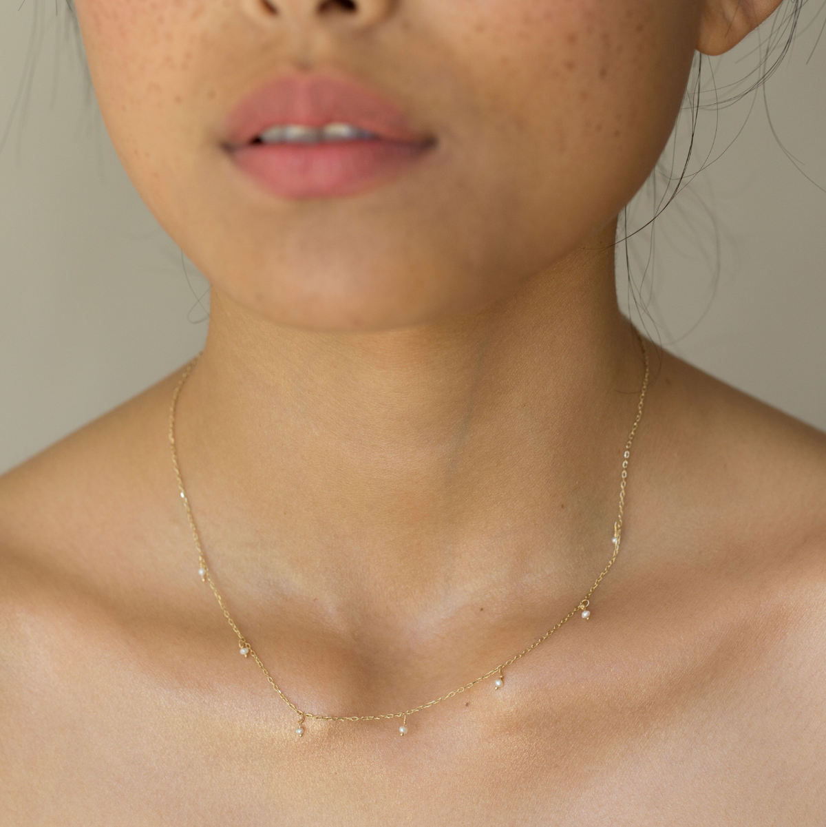 Pearl Shaker Necklace by Gjenmi worn at the collarbone
