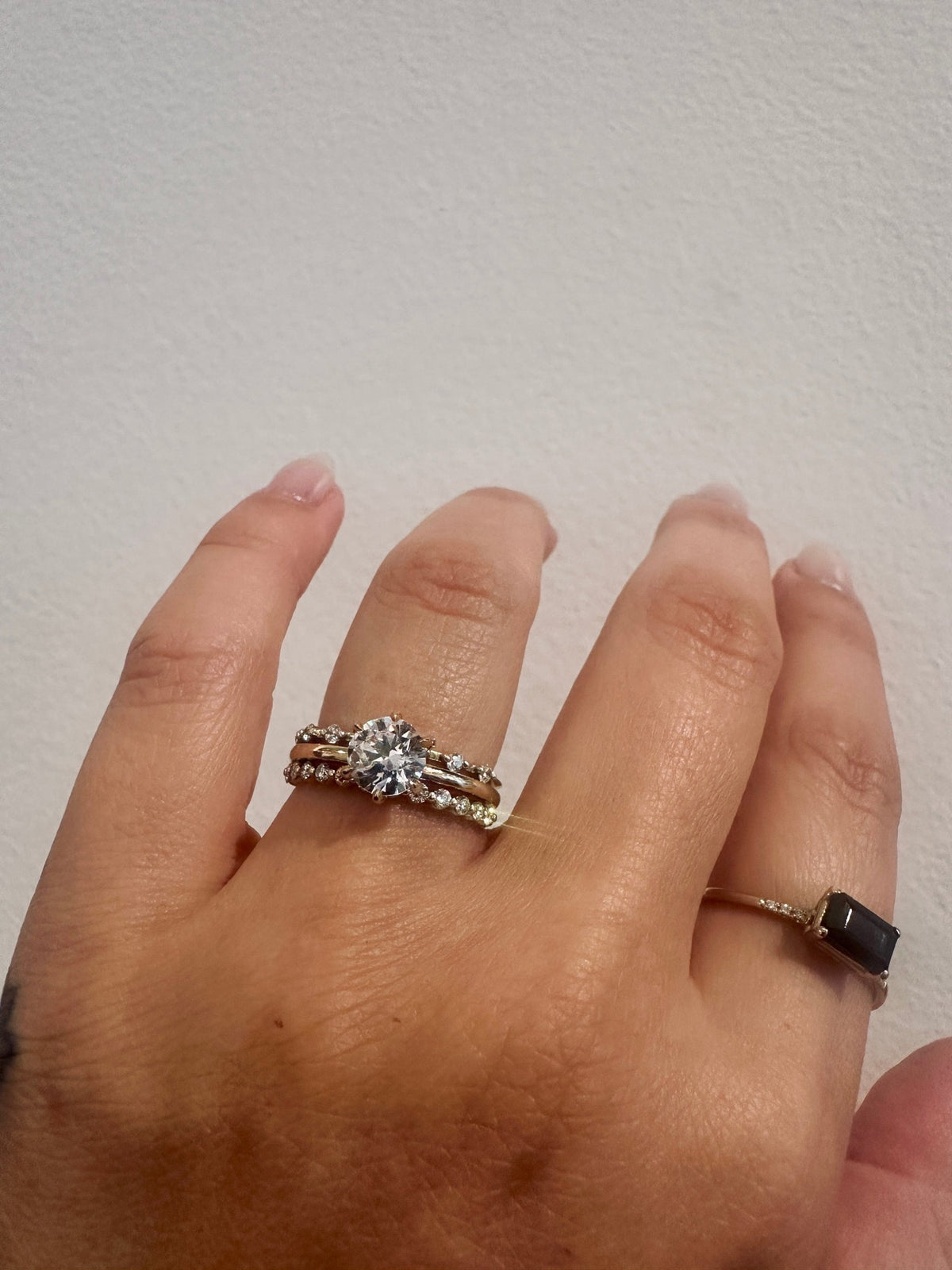 Diamond Dew wedding band in 14kt yellow gold with prong set round diamonds worn on the hand