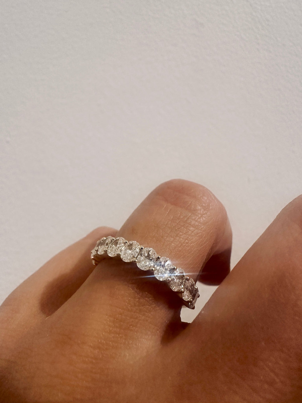 Oval diamond wedding band close up on hand