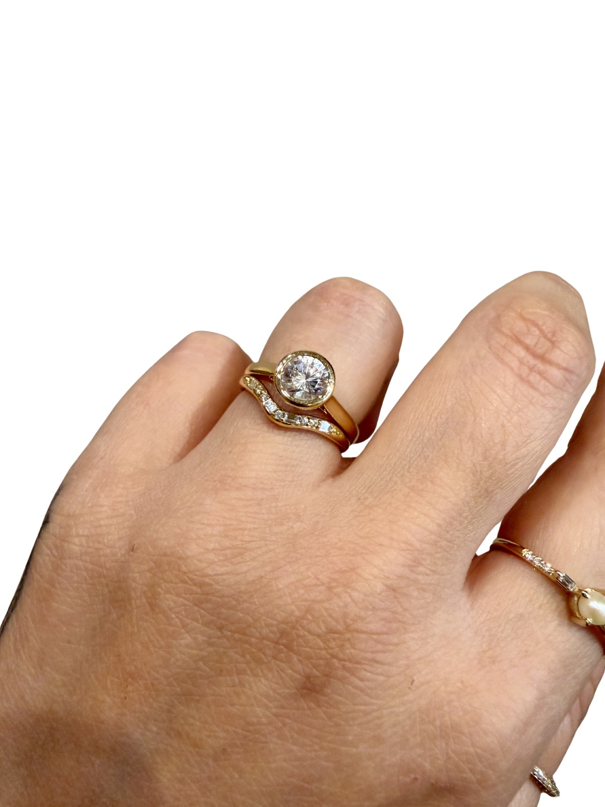 Diamond Staccato Wave Band by Jennie Kwon nested with a bezel set solitaire engagement ring