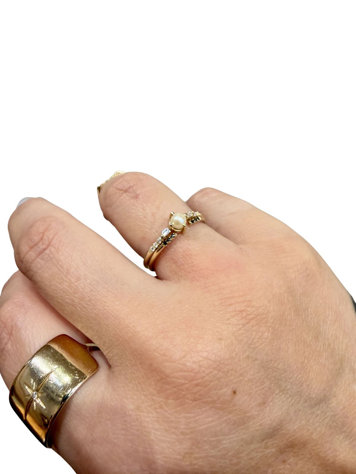 Solo Pearl Baguette Equilibrium Ring and Black Equilibrium Cuff by Jennie Kwon, worn together on the hand