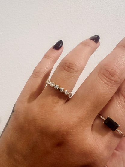 Diamond Deity wedding band in 14kt yellow gold with bezel set round diamonds worn on the hand