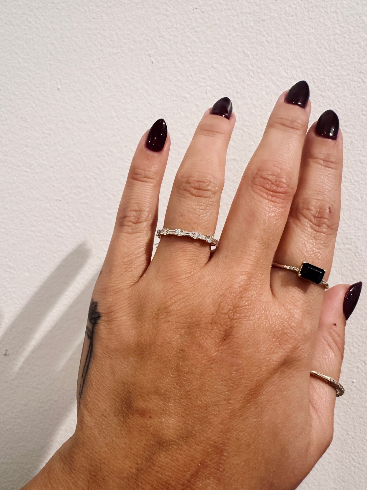 Cora Baguettes wedding band in 14kt yellow gold with baguette and round diamonds worn on the hand
