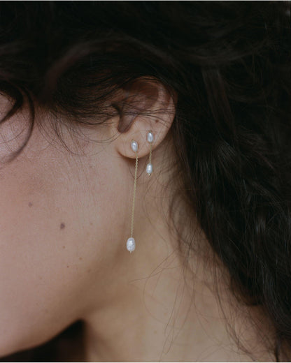 Long Pearl Shower Earrings worn with studs