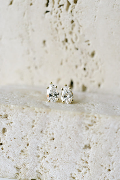 BB Prong Pear Dew Drops resting on travertine, close up