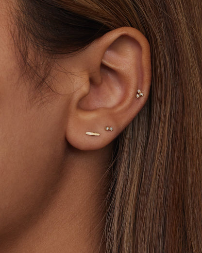 Gold Dash Wisp Earrings worn in an ear stack