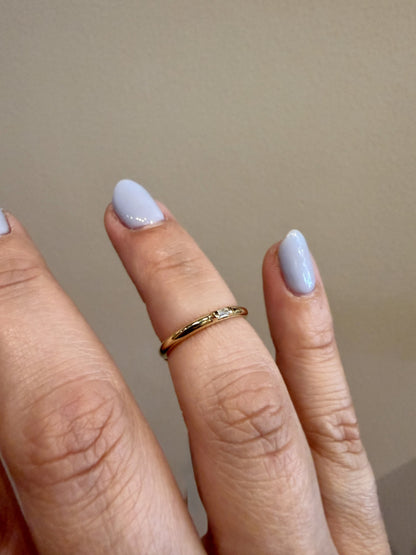 Diamond Baguette Accent Ring with a single baguette diamond in 14kt yellow gold worn on the hand, close up