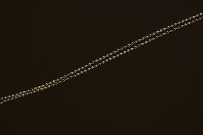 BB Ball Chain in 10kt yellow gold, a dainty diamond cut bead chain on a dark background