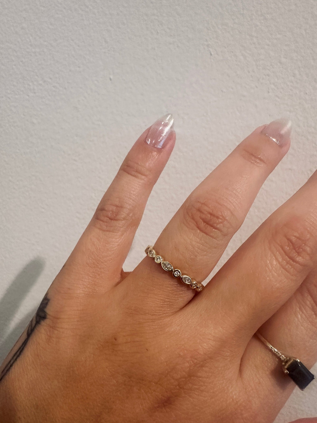 Diamond Harmony wedding band in 14kt yellow gold with marquise and round diamonds worn on the hand