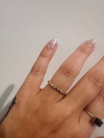 Diamond Harmony wedding band in 14kt yellow gold with marquise and round diamonds worn on the hand