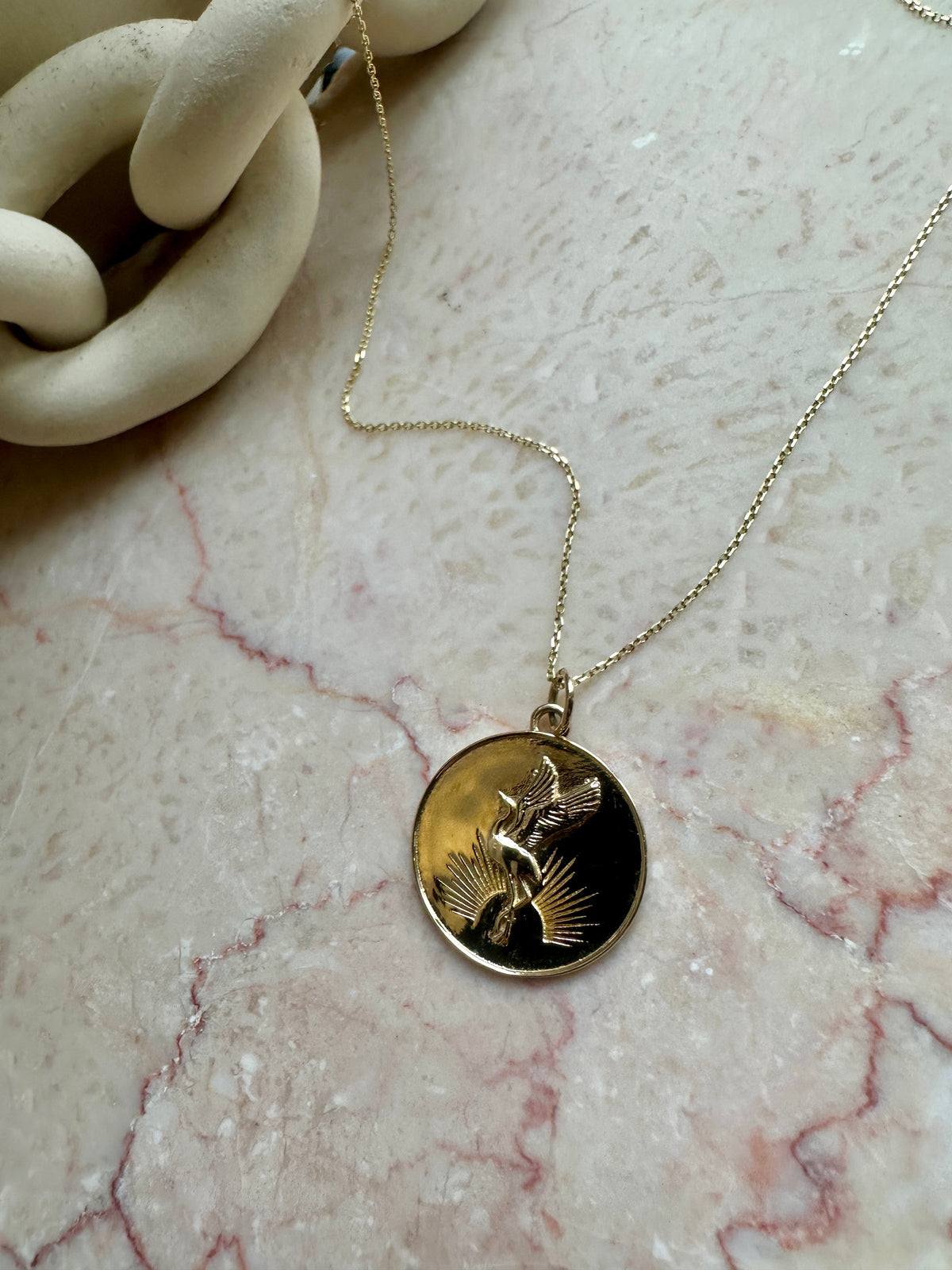 Sunrise Crane Medallion worn on chain