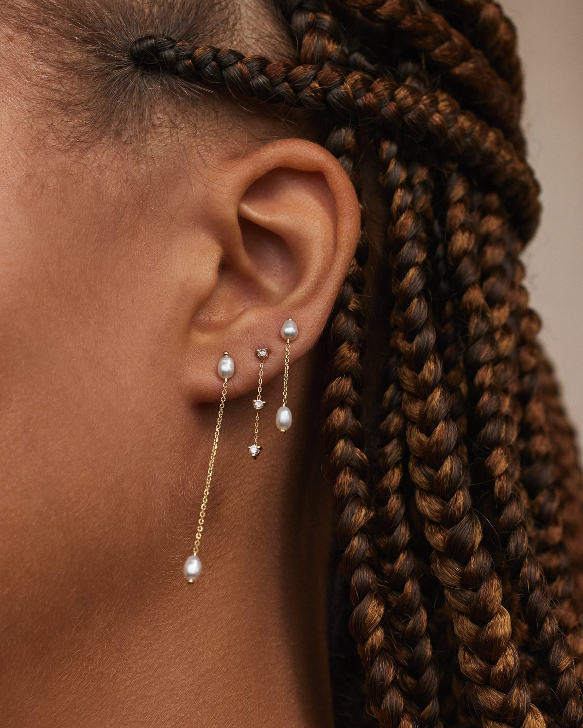 Pearl Shower Earrings styled in a multiple piercing ear stack
