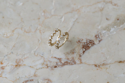 Compass Guides Huggies by Lane &amp; Kate in 14kt yellow gold with diamonds, on marble
