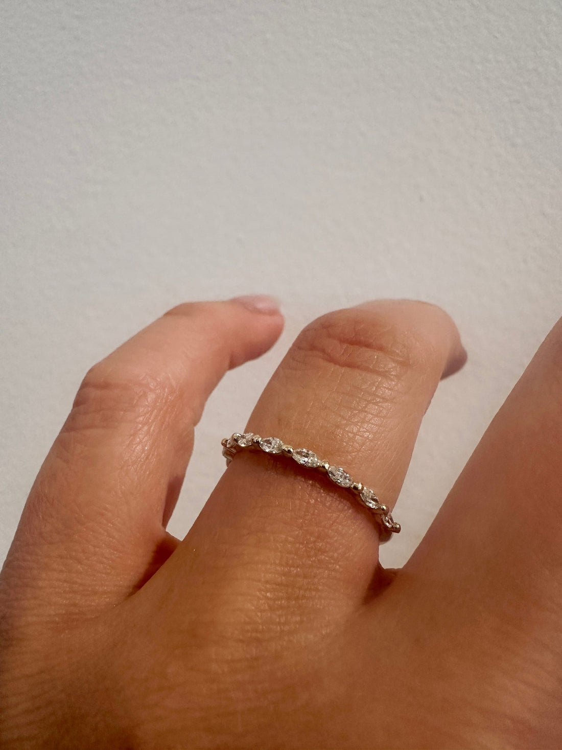 Marquise Gaze wedding band in 14kt yellow gold with prong set marquise diamonds worn on the hand