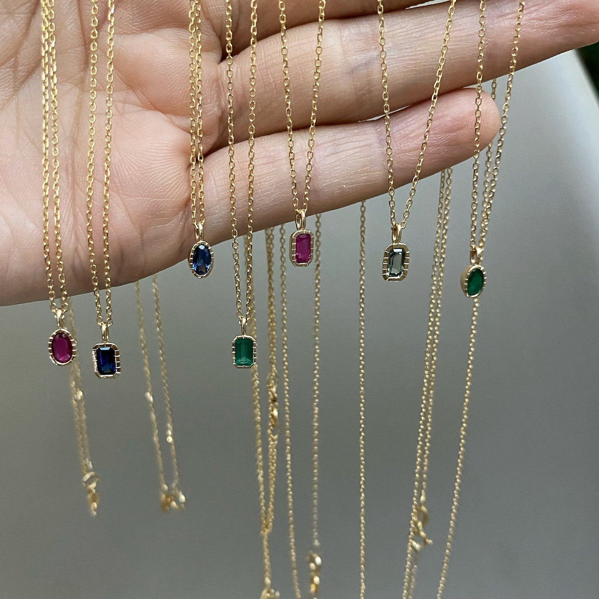 Jennie Kwon Oval Green Sapphire Wisp Necklace worn on model