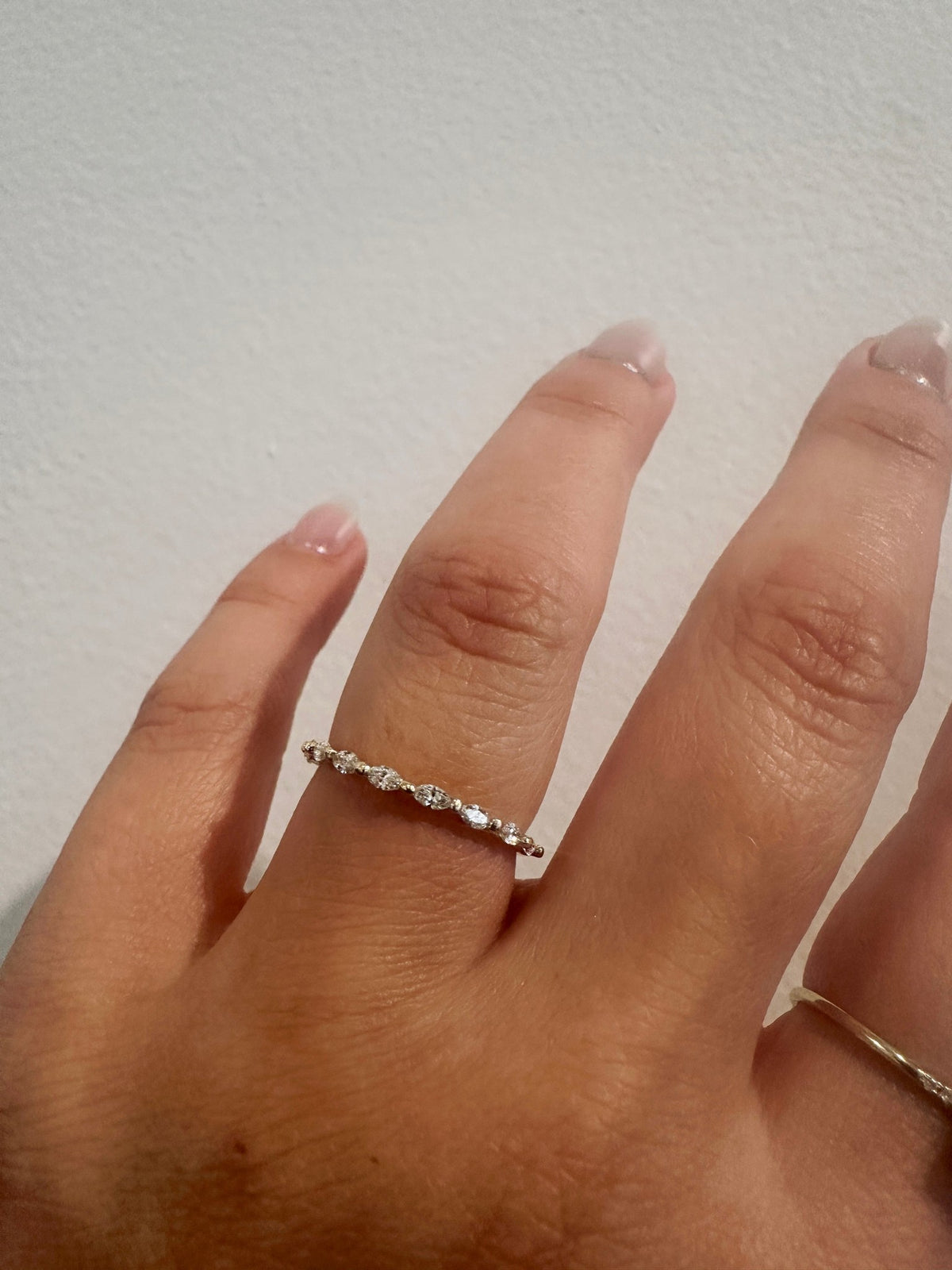 Marquise Gaze wedding band in 14kt yellow gold with prong set marquise diamonds worn on the hand