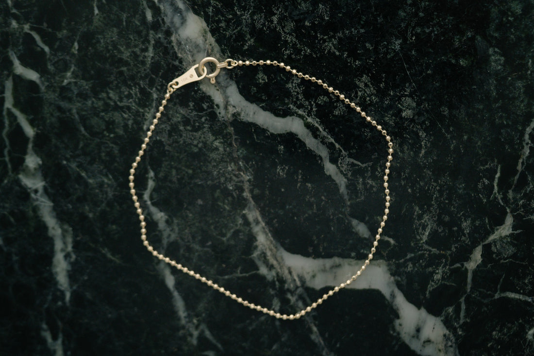 BB Ball Chain Bracelet by Lane &amp; Kate in gold, styled on green marble