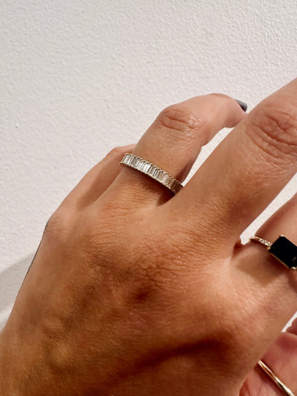 Baguette diamond cigar style wedding band close up on hand