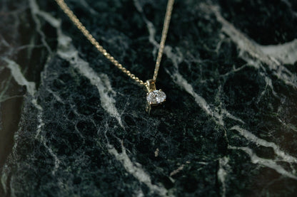 Oval Prism Necklace, oval lab grown diamond solitaire in 14kt yellow gold on green marble