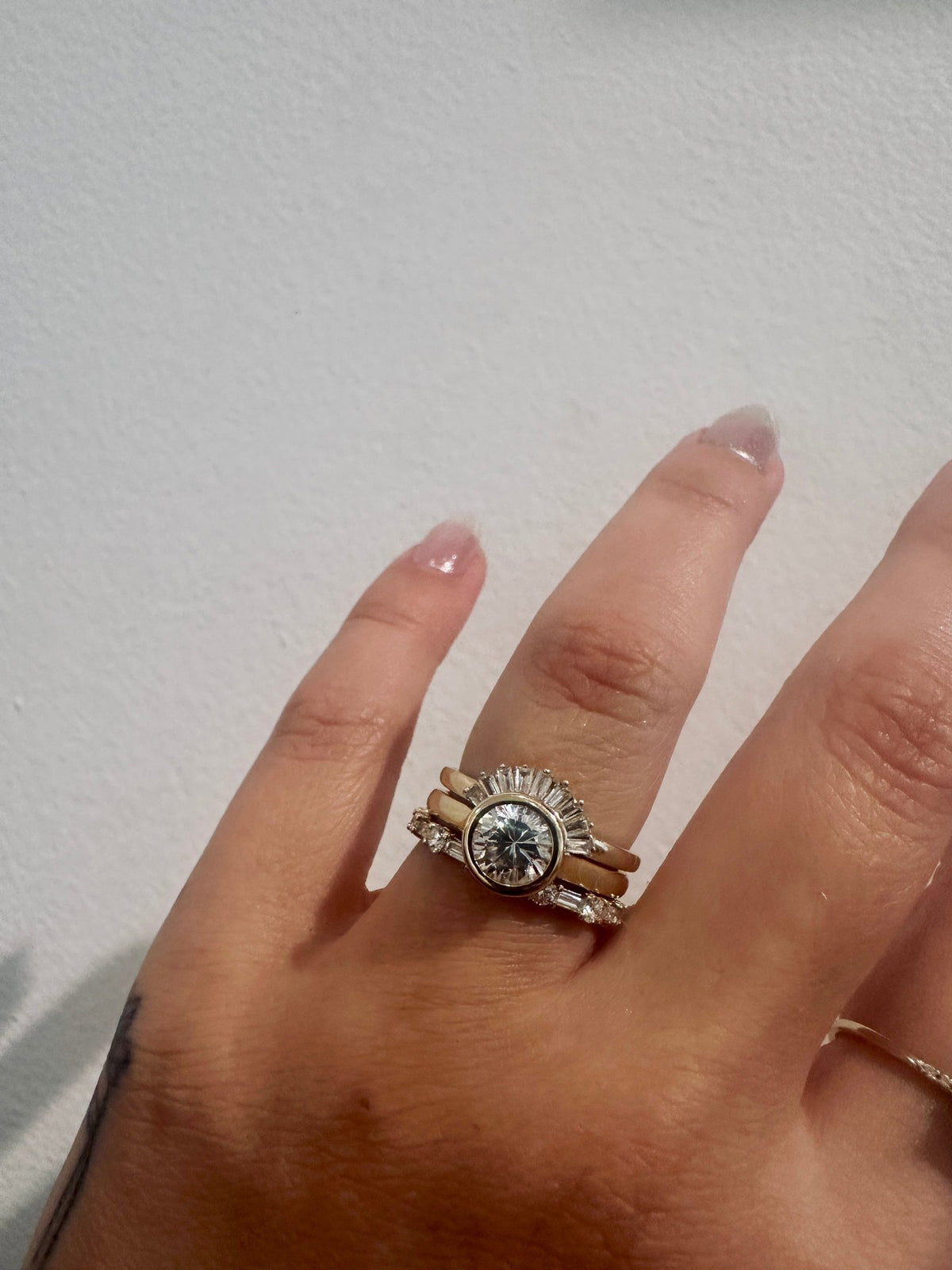 Cora Baguettes wedding band in 14kt yellow gold with baguette and round diamonds worn on the hand
