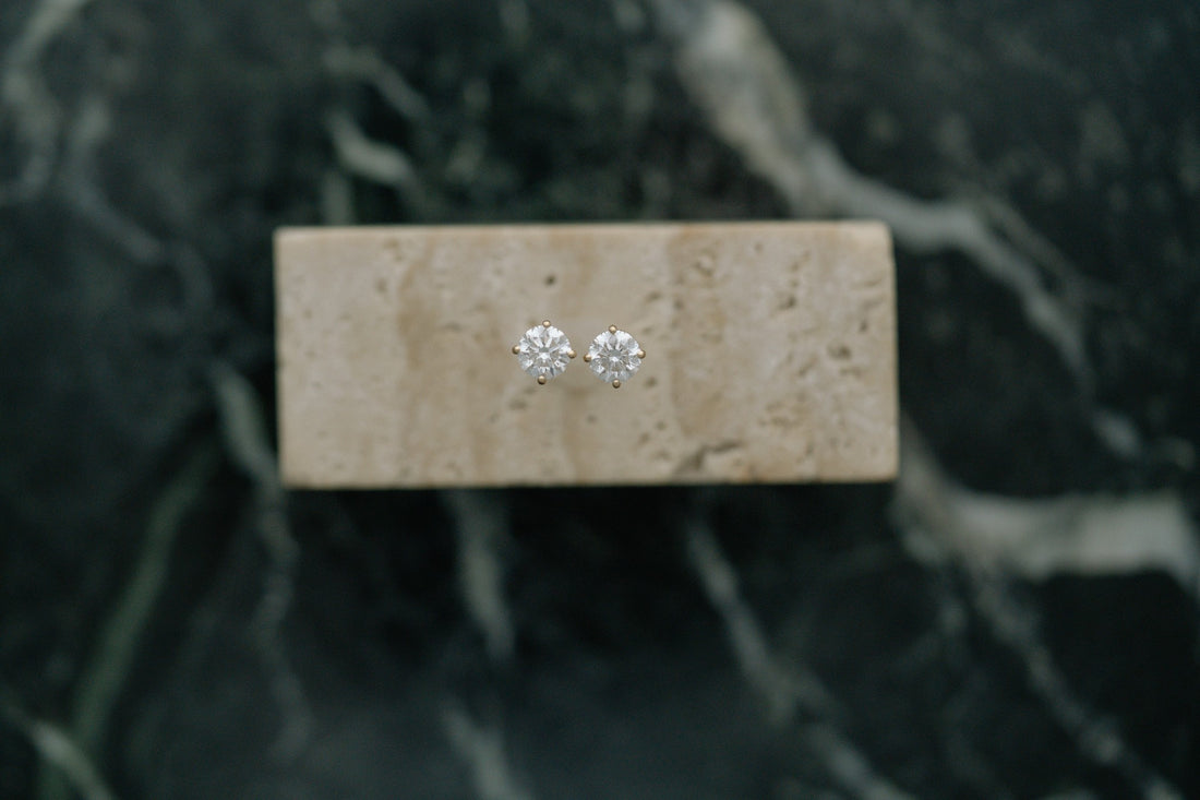 Classic Natural Diamond Earrings by Lane &amp; Kate, round diamond studs styled on travertine and green marble