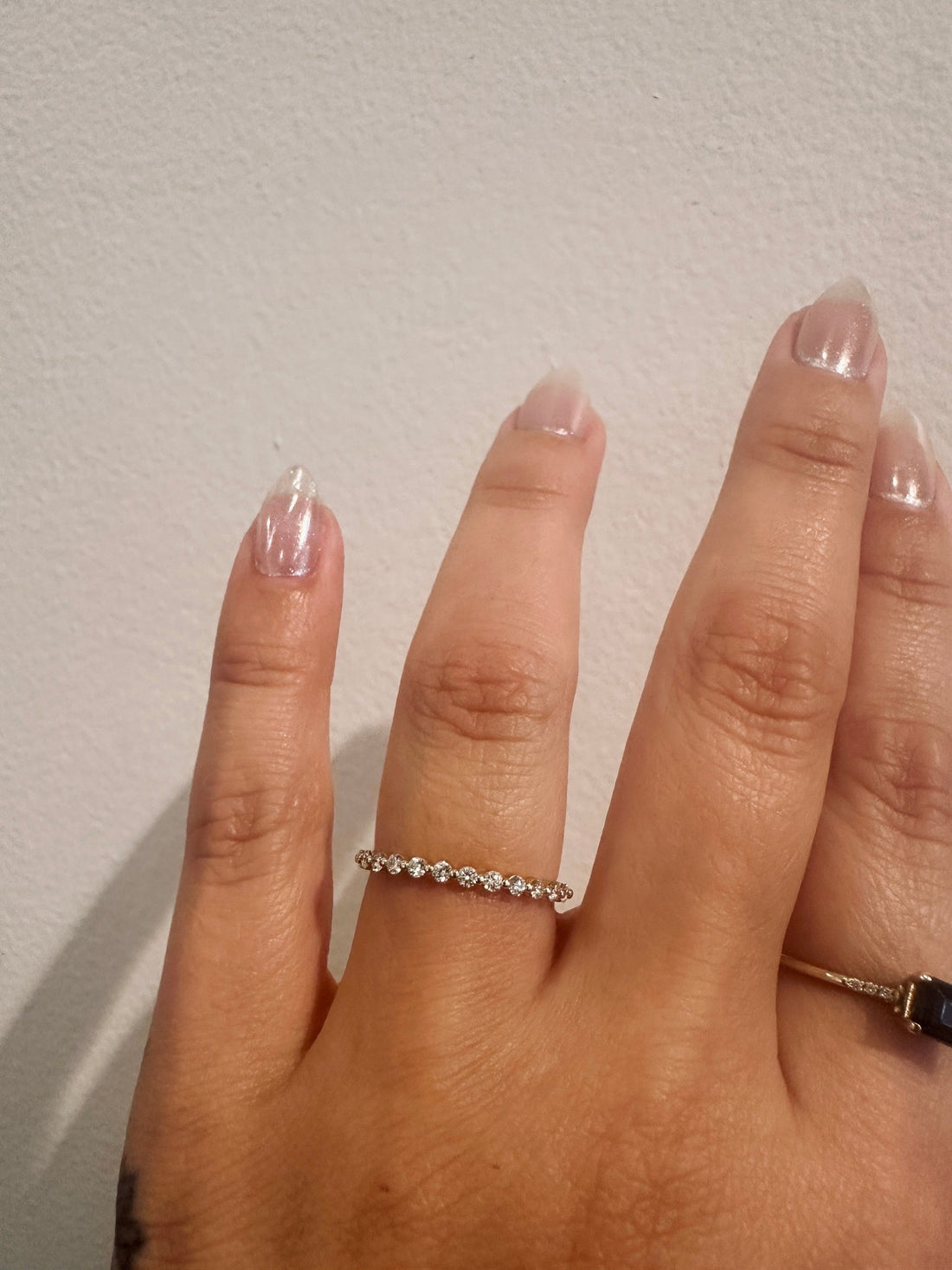 Diamond Dew wedding band in 14kt yellow gold with prong set round diamonds worn on the hand