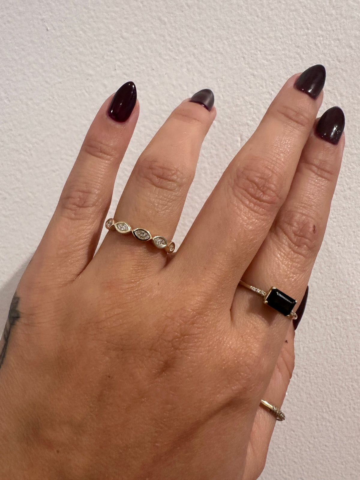 Marquise Ambitions wedding band in 14kt yellow gold with bezel set marquise diamonds worn on the hand