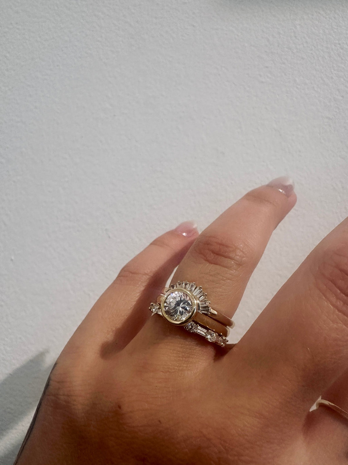 Cora Baguettes wedding band in 14kt yellow gold with baguette and round diamonds worn on the hand
