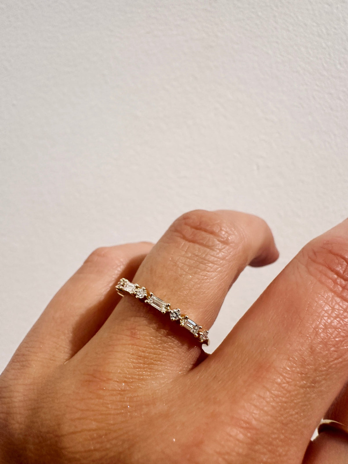 Golden Dusk Wedding Band with alternating baguette and round diamonds worn on hand