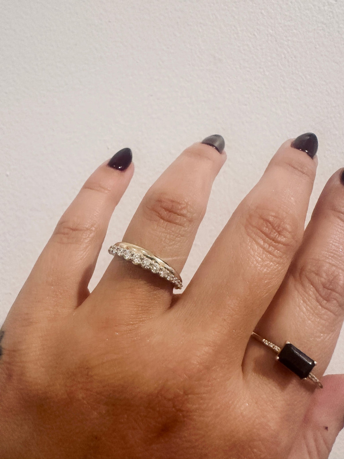 Golden Dawns wedding band in 14kt yellow gold with graduated round diamonds worn on the hand