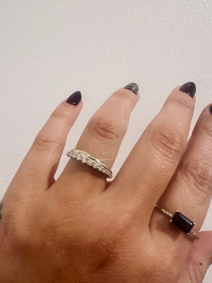 Golden Dawns wedding band in 14kt yellow gold with graduated round diamonds worn on the hand