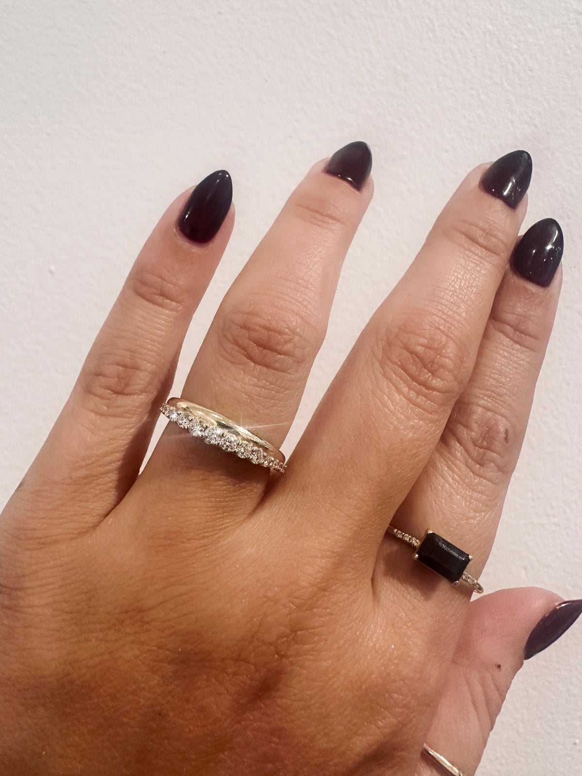 Golden Dawns wedding band in 14kt yellow gold with graduated round diamonds worn on the hand