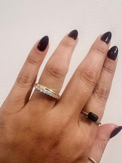 Golden Dawns wedding band in 14kt yellow gold with graduated round diamonds worn on the hand