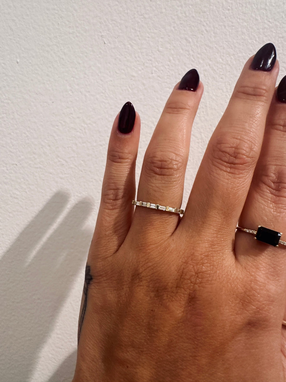 Baguette Sol wedding band in 14kt yellow gold with baguette diamonds worn on the hand