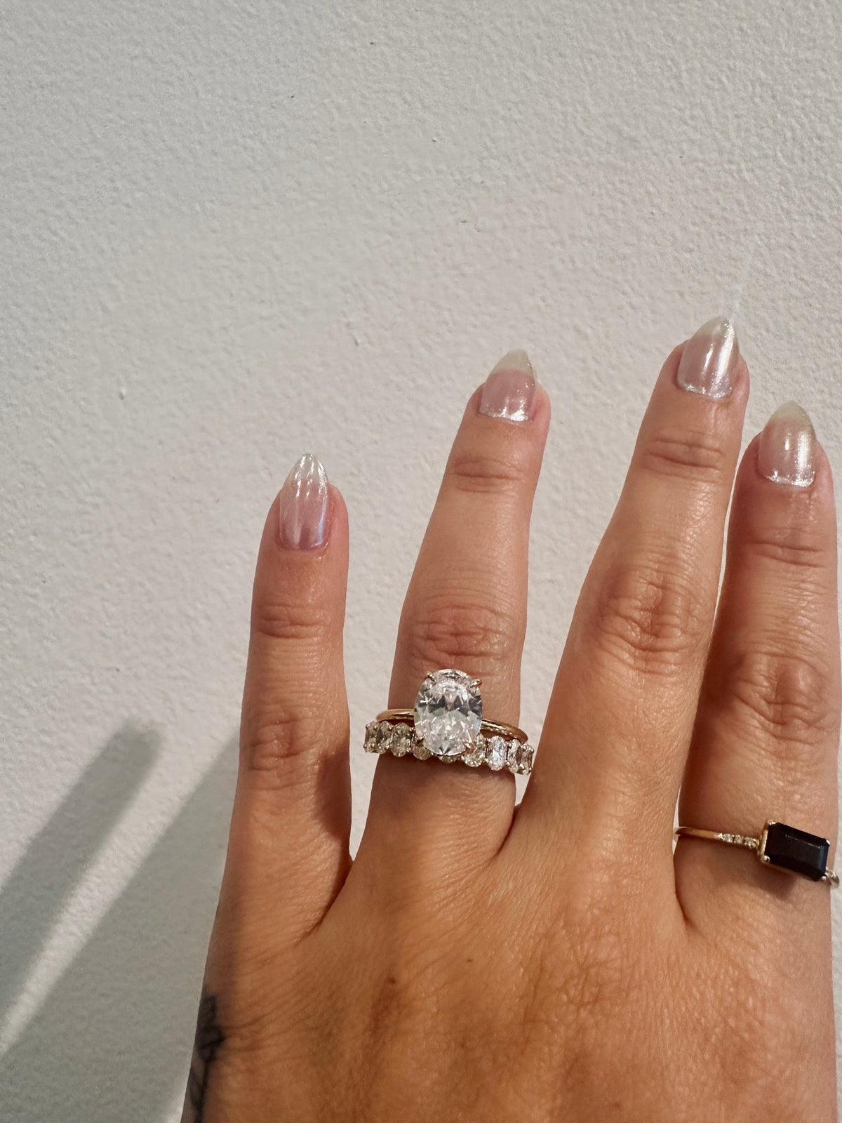 Oval diamond wedding band paired with an oval engagement ring