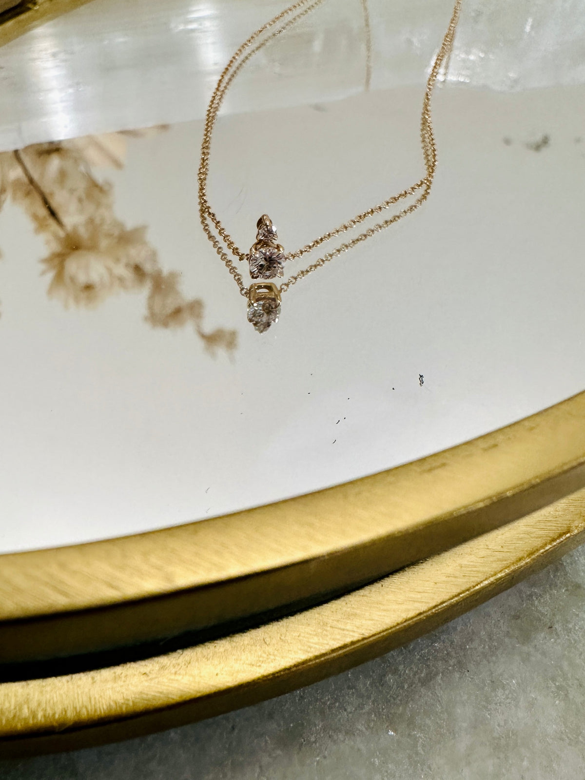 Diamond Horizon Pendant styled over a gold dish