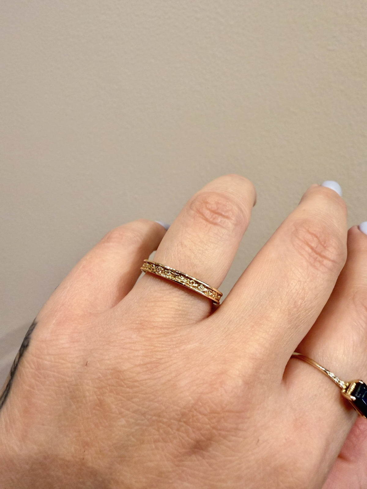 Golden Gardens Band engraved floral band in 14kt yellow gold worn on the hand
