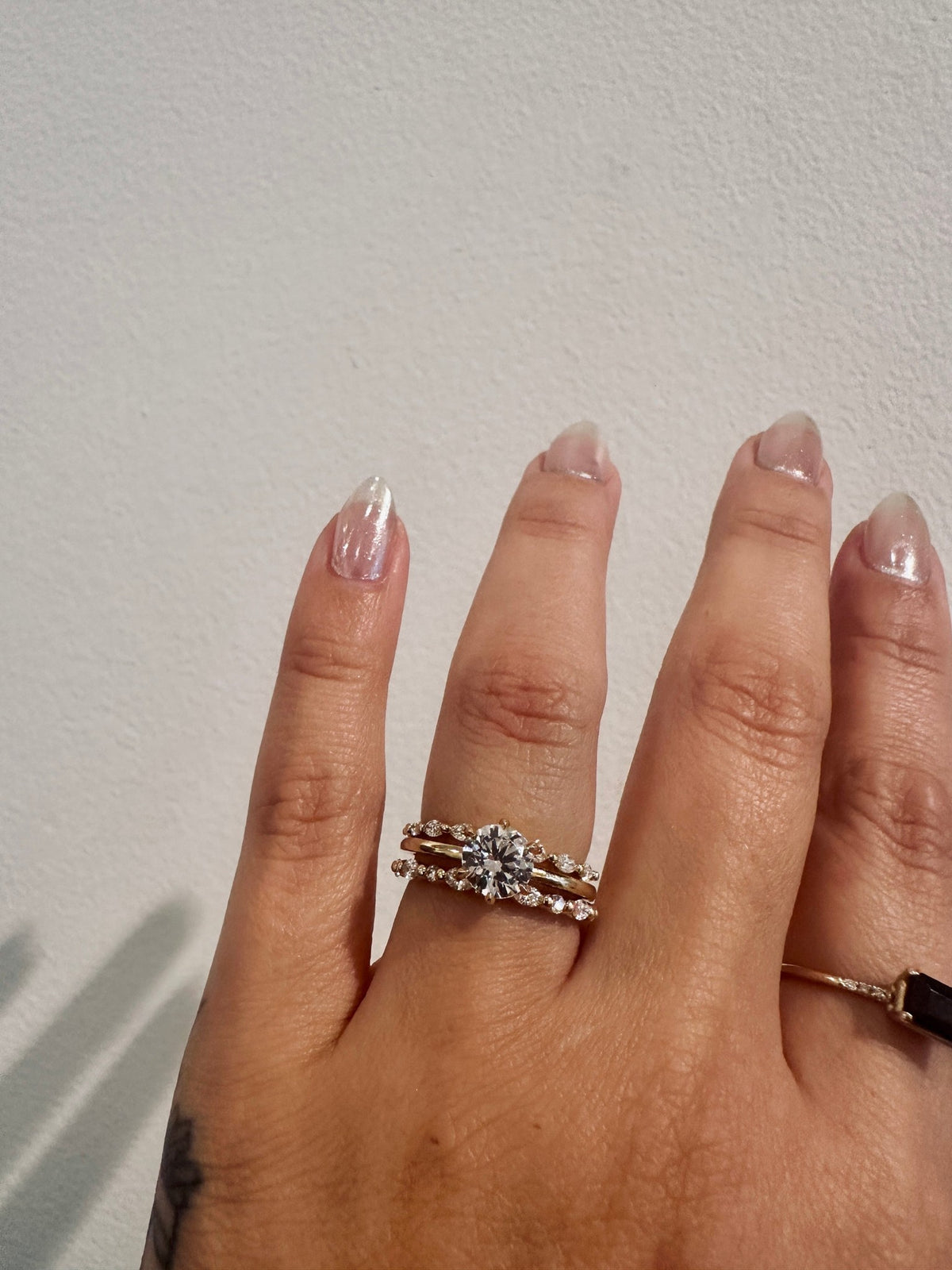 Marquise Gaze wedding band in 14kt yellow gold with prong set marquise diamonds worn on the hand