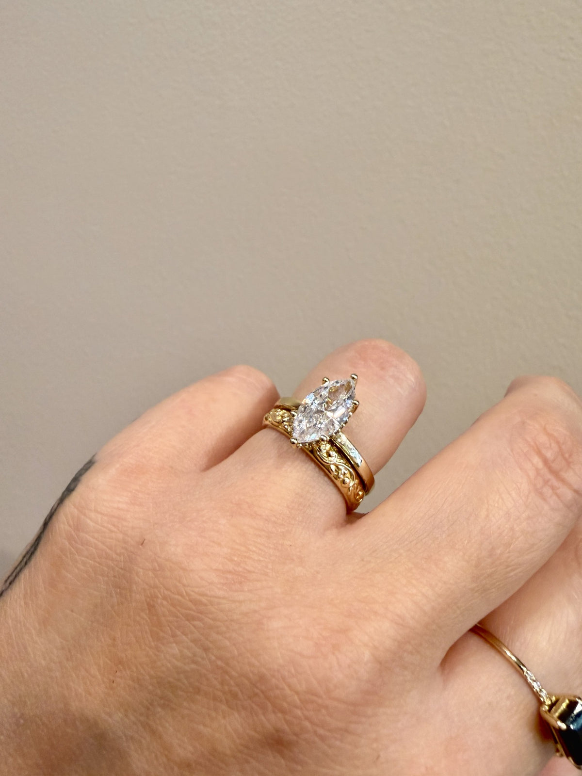 Golden Floral Band sculpted floral band in 14kt yellow gold paired with a marquise engagement ring