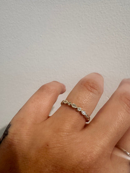 Diamond Harmony wedding band in 14kt yellow gold with marquise and round diamonds worn on the hand