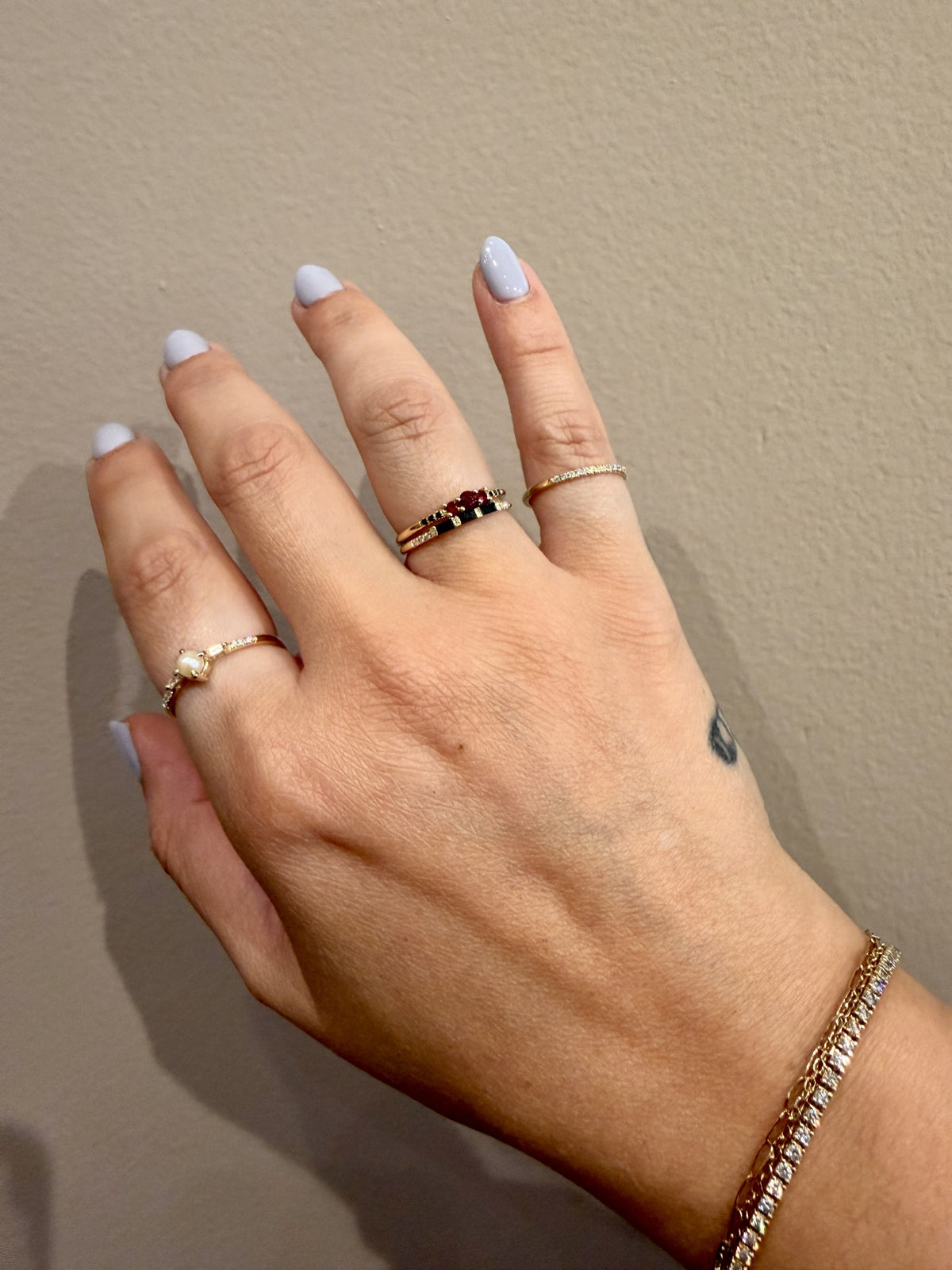 Three Black Diamond Baguette Band in 14kt yellow gold stacked with the Tres Ruby Ring