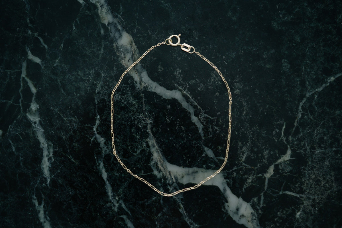 Ripple Chain Bracelet by Lane &amp; Kate in 14kt yellow gold, styled on green marble
