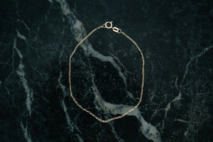 Ripple Chain Bracelet by Lane &amp; Kate in 14kt yellow gold, styled on green marble
