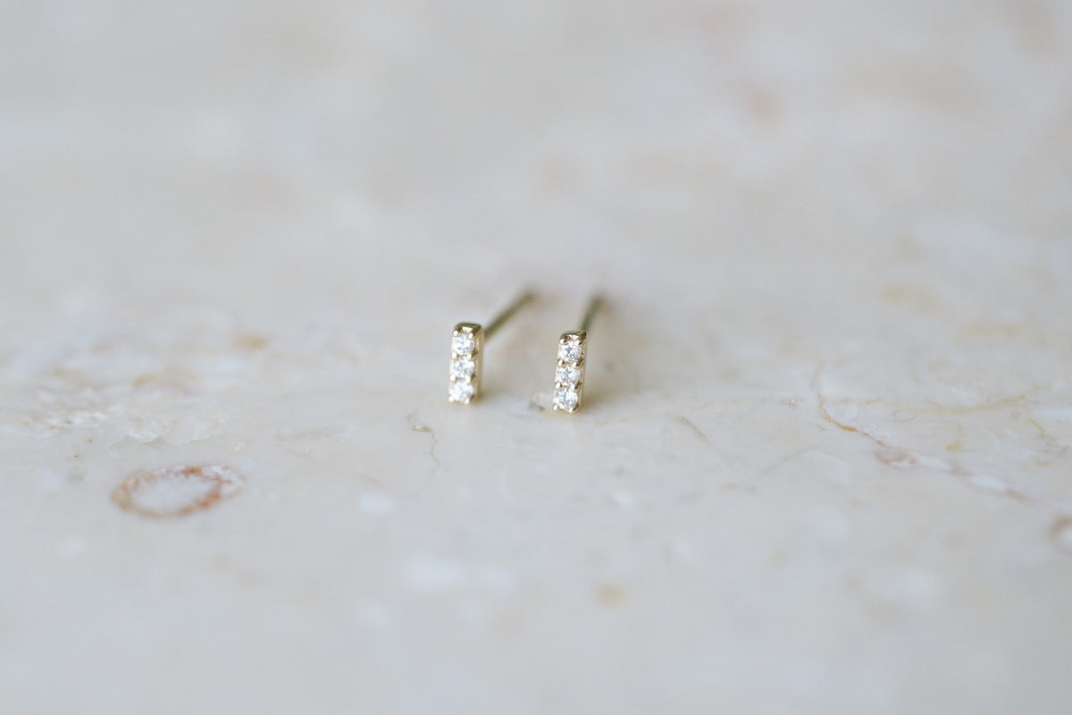 BB Three Diamond Bars, 14kt yellow gold bar studs with three natural diamonds on stone