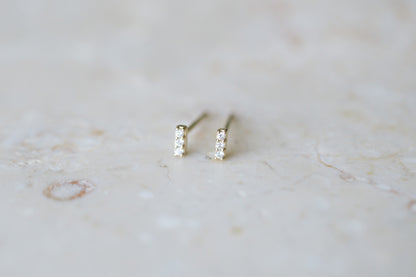BB Three Diamond Bars, 14kt yellow gold bar studs with three natural diamonds on stone