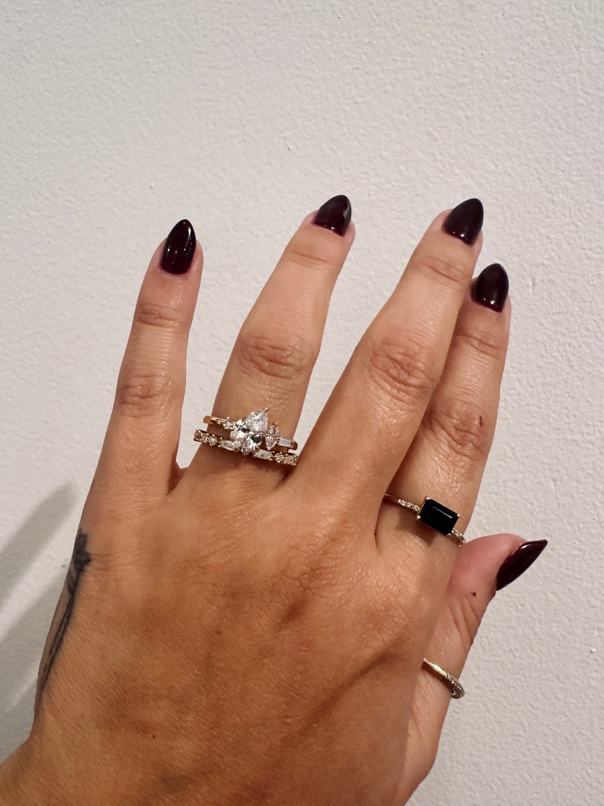 Golden Dusk Wedding Band paired with a diamond engagement ring on hand