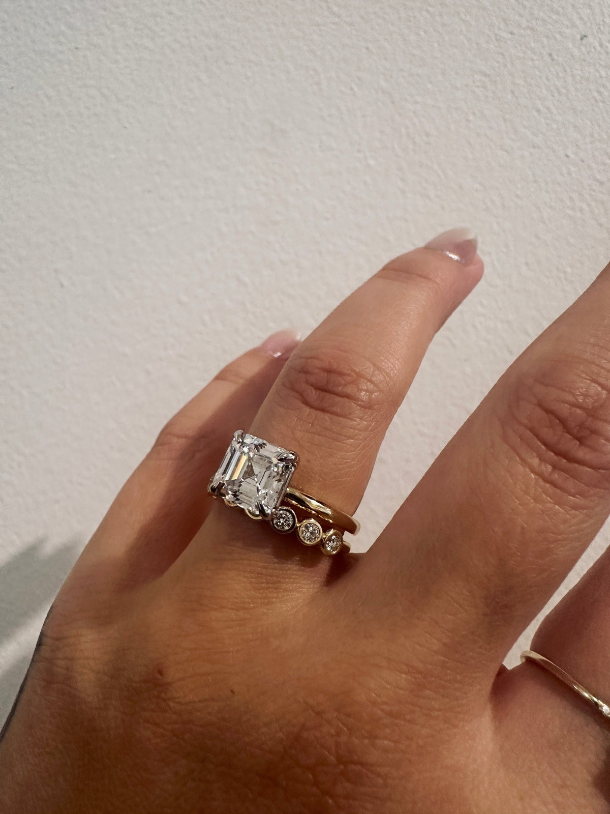 Diamond Deity wedding band in 14kt yellow gold with bezel set round diamonds worn on the hand