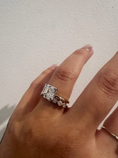 Diamond Deity wedding band in 14kt yellow gold with bezel set round diamonds worn on the hand