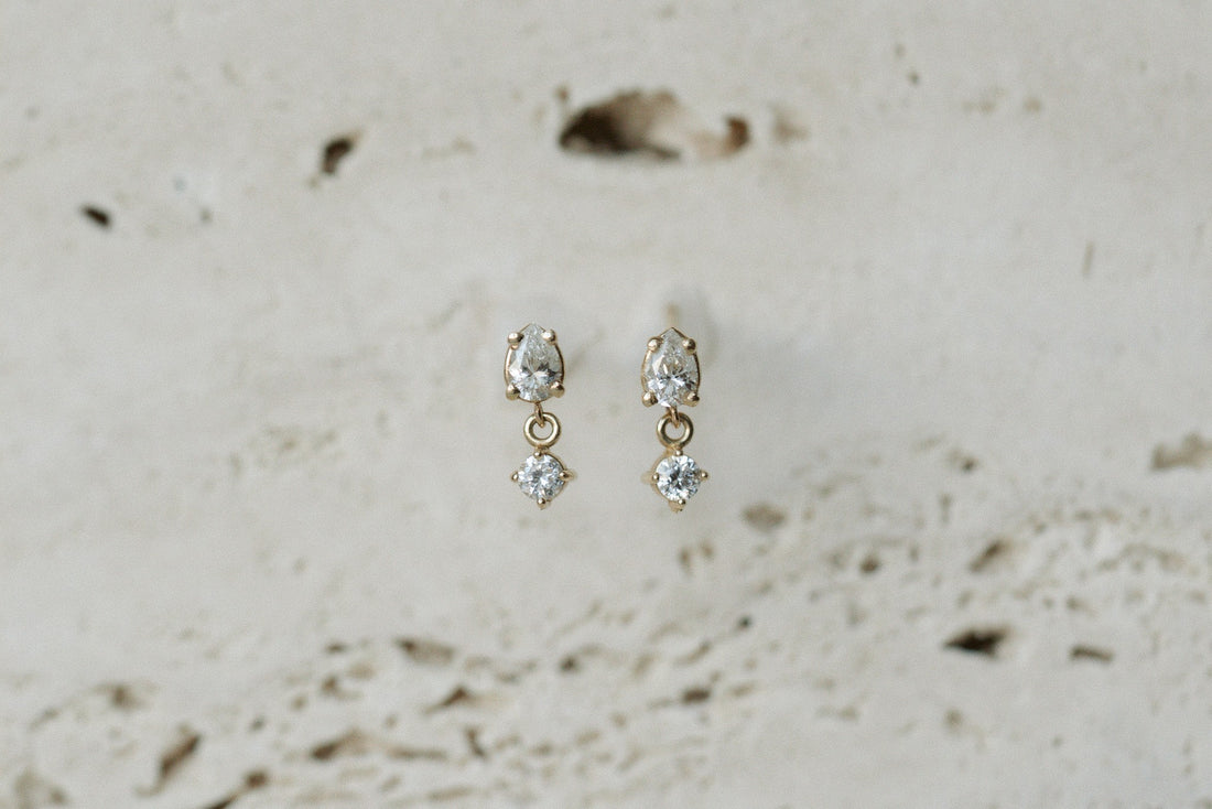 Zoe Chicco Pear &amp; Round Diamond Link Drop Earrings in 14kt yellow gold on travertine